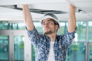 Contractor performing overhead ceiling work