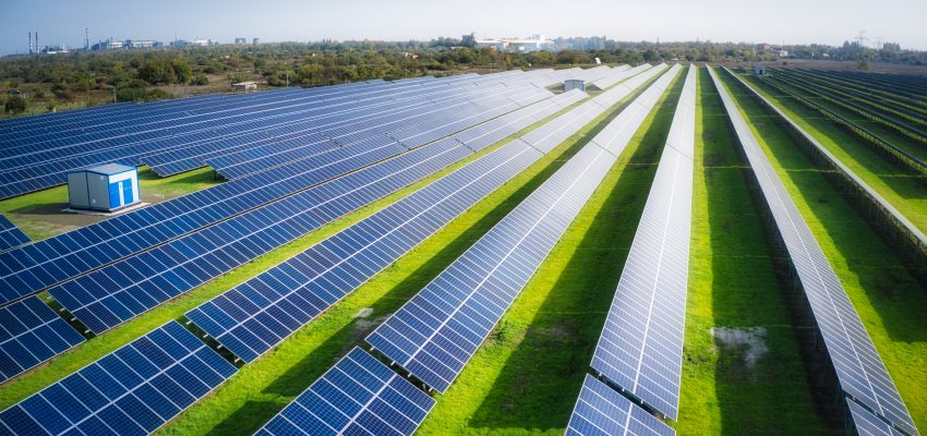 Huge solar power plant to use solar energy in a picturesque green field